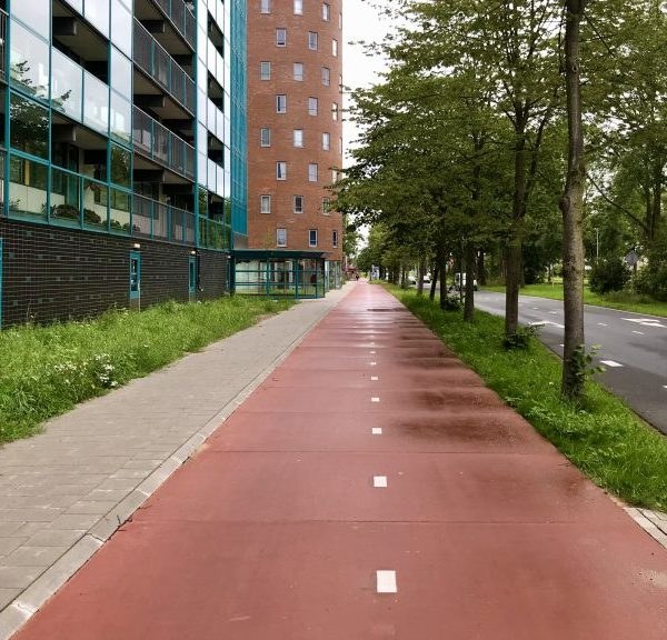 Rood prefab Ecopath-fietspad in een stedelijke omgeving